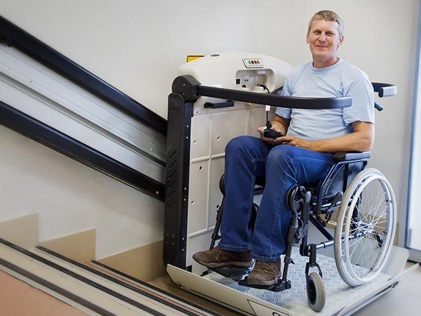 Man in wheelchair using a stair lift